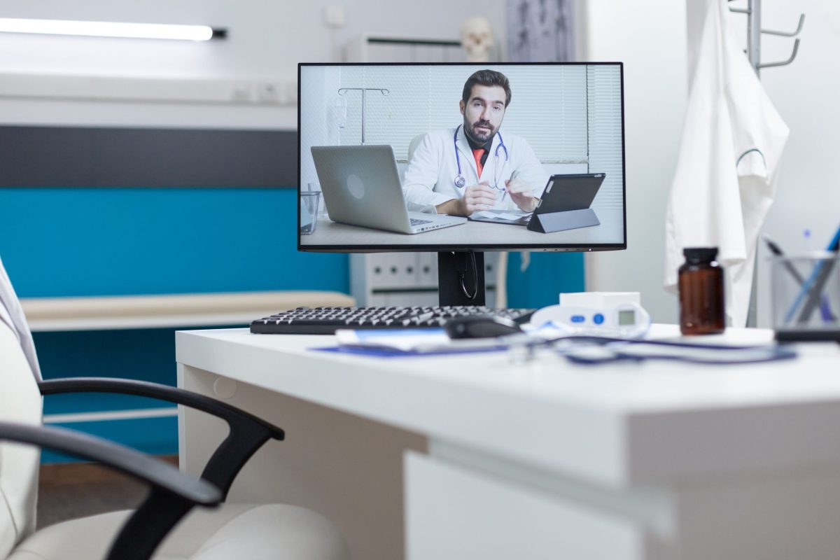 computer-screen-with-remote-doctor-having-online-videocall-meeting-conference-standing-table-empty-hospital-office-telework-videoconference-call-during-medical-consultation-medicine-concept-scaled-e1679982635738.jpg